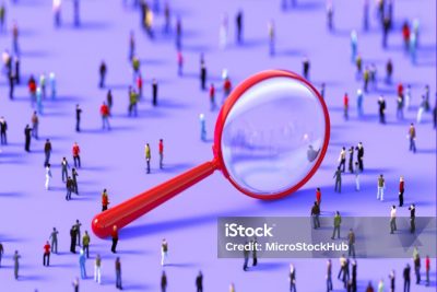 Human crowd surrounding a red magnifier object on purple background. Vertical  composition with copy space.